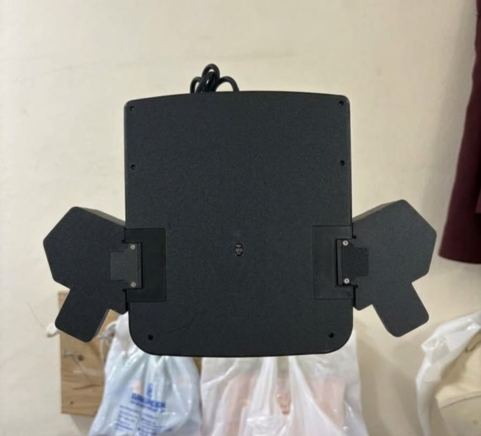 Underside of the ERCHAM MK1 functional prototype showing the optical sensor window and the slide-on mounts for both thumb clusters